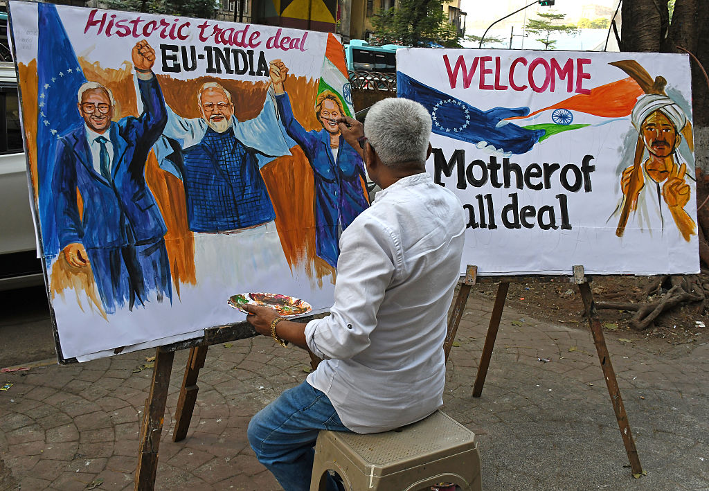 A teacher from Gurukul school of art paints an art piece